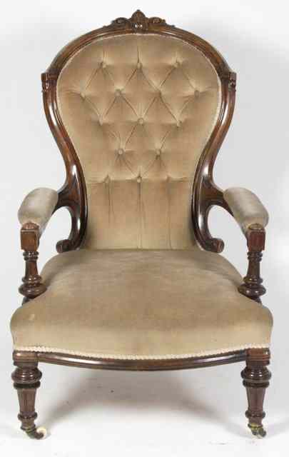 Appraisal: A late Victorian walnut armchair with deep button back on