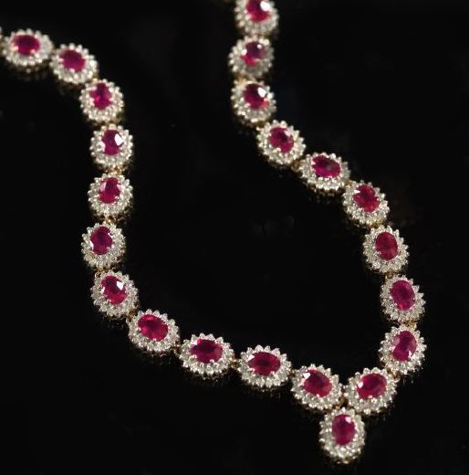 Appraisal: Fourteen-Karat Yellow Gold Ruby and Diamond Necklace the flexible ribbon