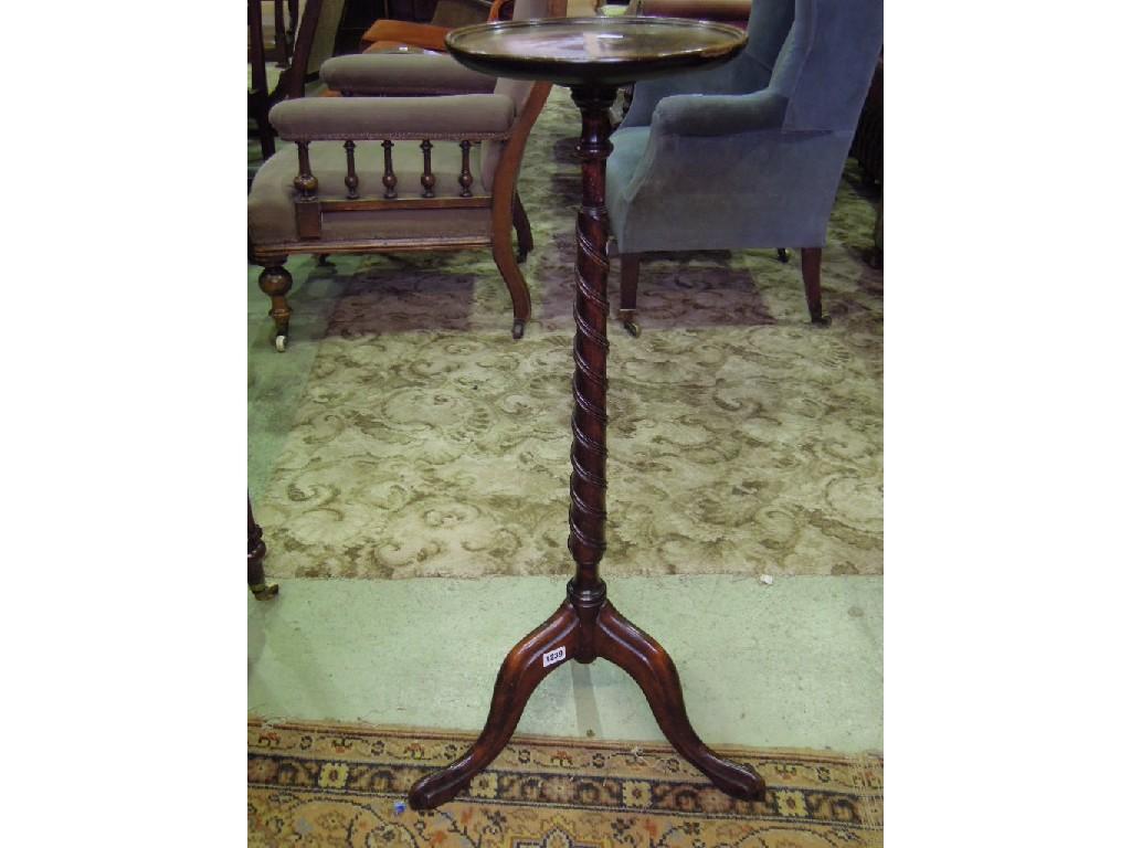 Appraisal: A reproduction mahogany torchere in the Georgian style the circular