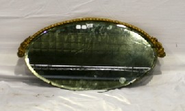 Appraisal: An elliptical wall mirror with roped giltwood decoration cm high