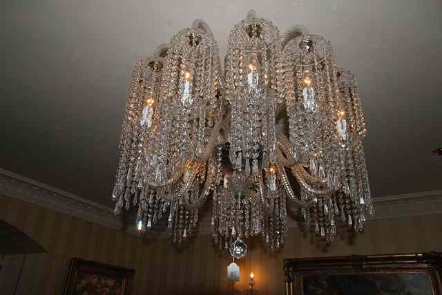 Appraisal: A CUT GLASS TWELVE LIGHT ELECTROLIER with cable twist scrolling