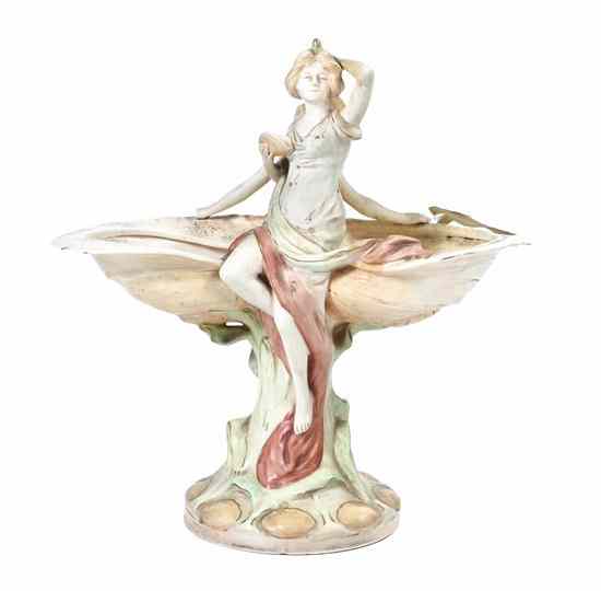 Appraisal: A Czechoslovakian Art Nouveau Figural Centerpiece depicting two maidens surmounting