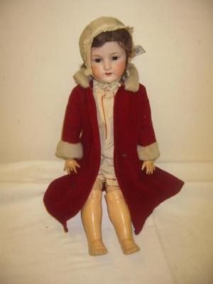 Appraisal: An Ernst Heubach bisque head girl doll with brown glass