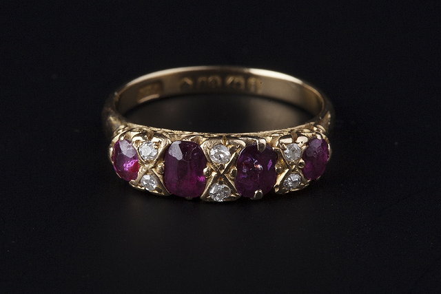 Appraisal: AN EDWARDIAN RUBY AND DIAMOND HALF HOOP RING set with