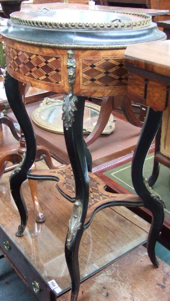 Appraisal: A th century French oval ebonised and parquetry inlaid gilt