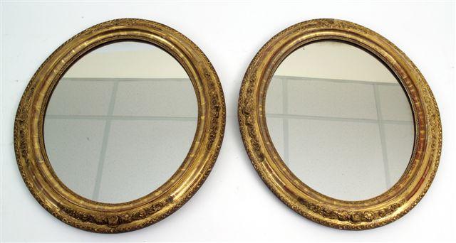 Appraisal: PAIR OF th CENTURY GILT-COMPOSITION OVAL MIRRORS each moulded with