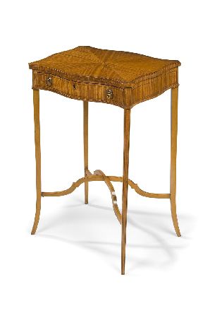 Appraisal: An Edwardian serpentine satinwood and banded occasional table the radially