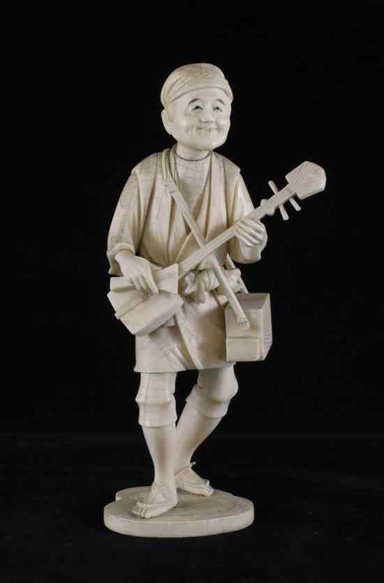 Appraisal: A large Japanese sectional walrus ivory figure of a musician