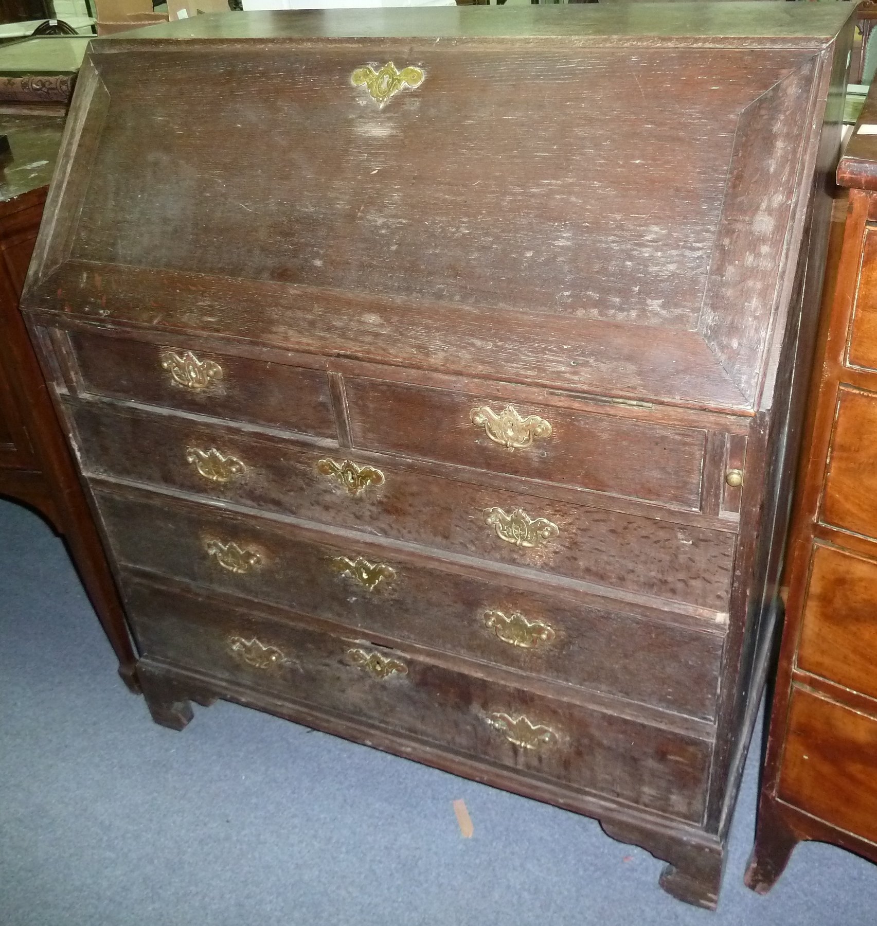 Appraisal: A George III oak bureau the fall front enclosing a