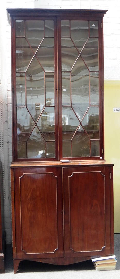 Appraisal: A George III mahogany bookcase cupboard the astragal glazed two