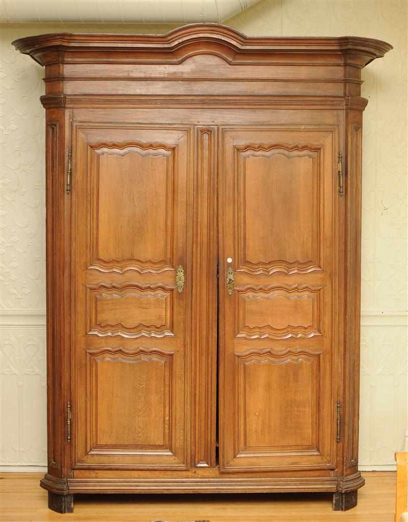 Appraisal: LOUIS XVI CARVED OAK ARMOIRE With an overhanging molded cornice