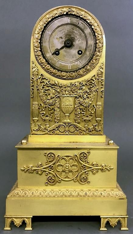 Appraisal: French Brass Clock with Relief Urn of Flowers French brass