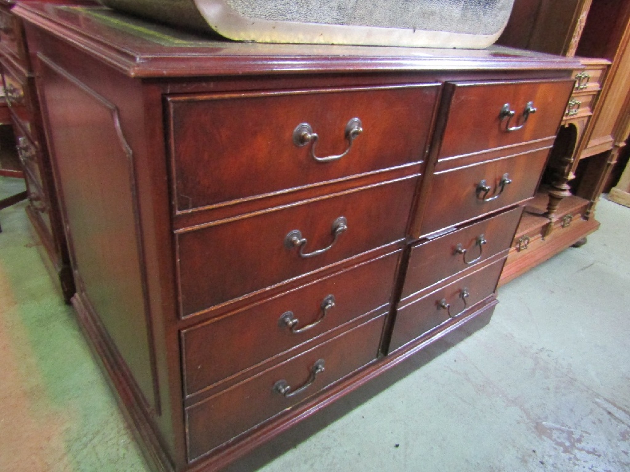 Appraisal: A reproduction floorstanding four drawer filing cabinet in the Georgian