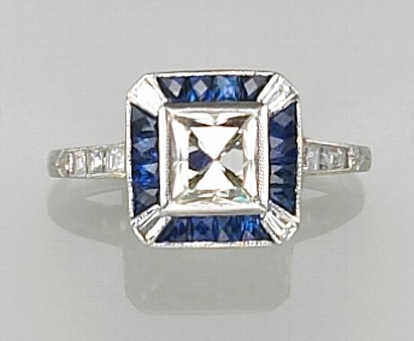 Appraisal: A diamond sapphire and platinum ring centering a square-cut diamond