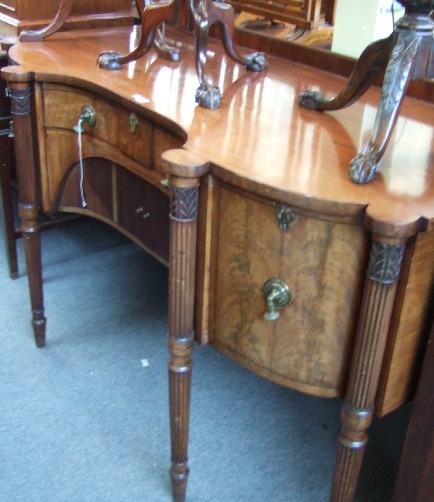 Appraisal: A late George III mahogany sideboard with a ledged back