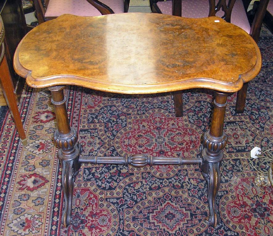 Appraisal: A Victorian figured walnut occasional table -