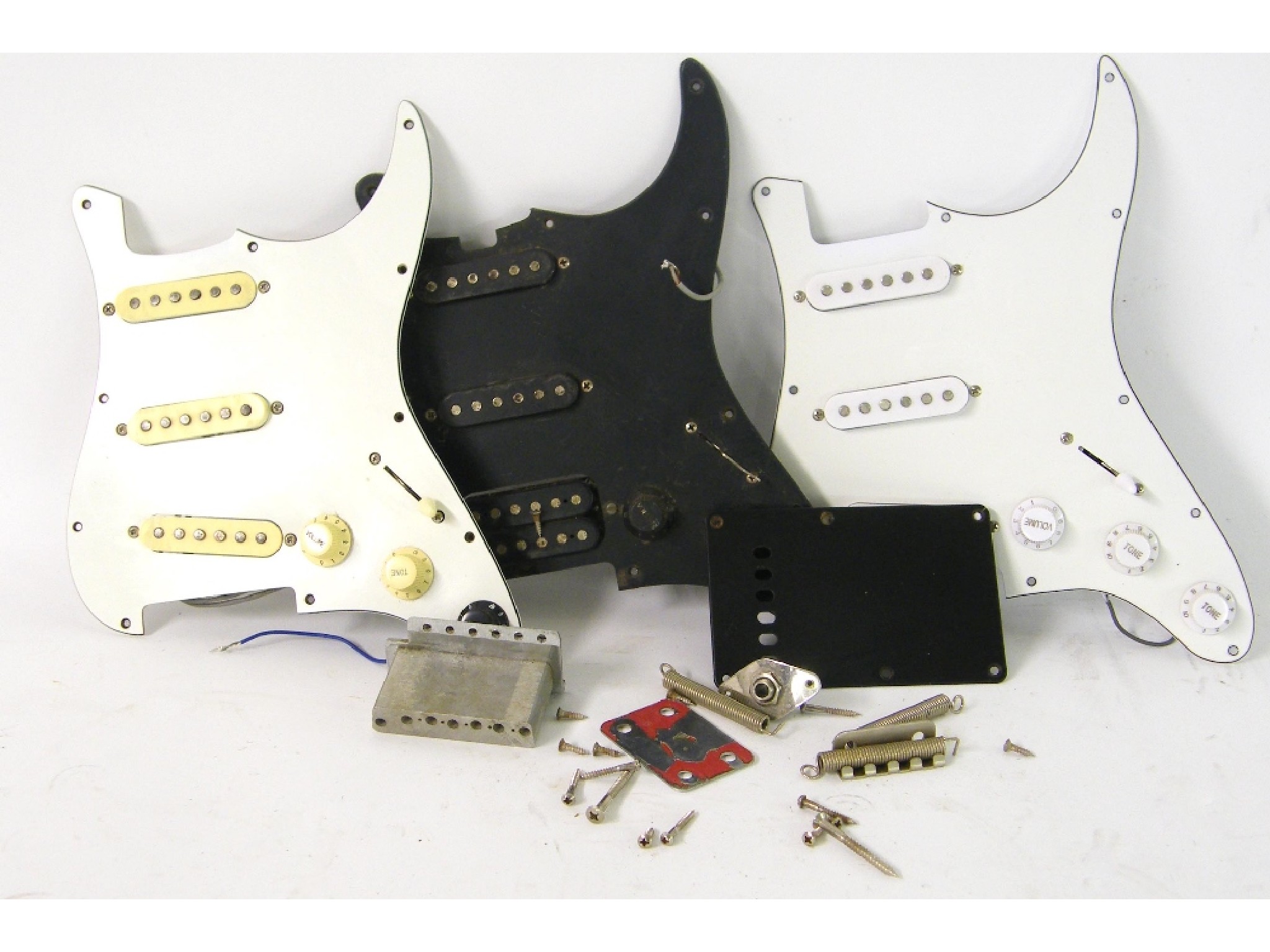 Appraisal: Three loaded Stratocaster style guitar scratchplates together with a Tremolo