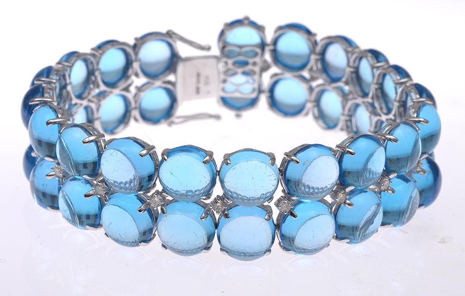 Appraisal: A CABOCHON CUT TOPAZ BRACELET WITH DIAMOND DETAIL IN CT