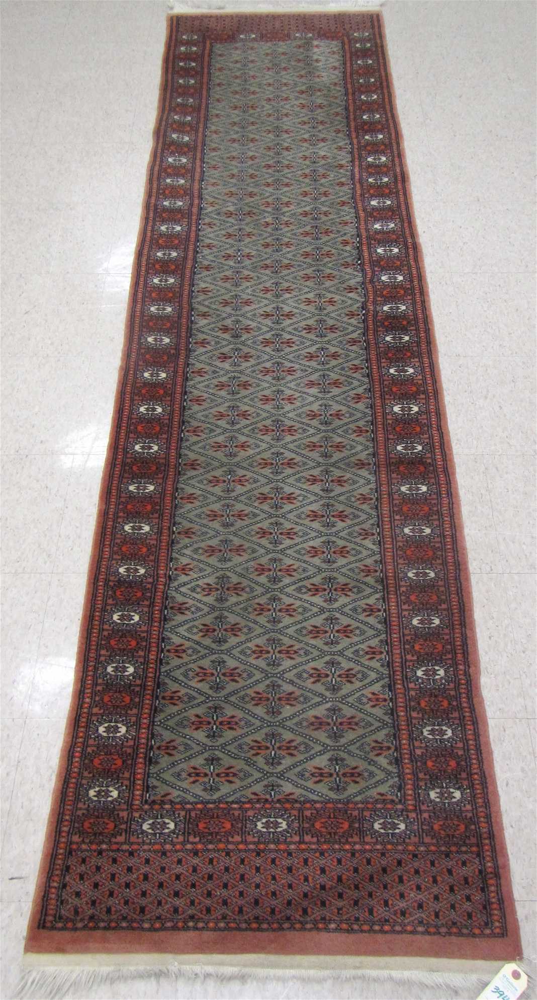 Appraisal: HAND KNOTTED ORIENTAL HALL RUG Pakistani Bokhara repeating diamond-shaped gol