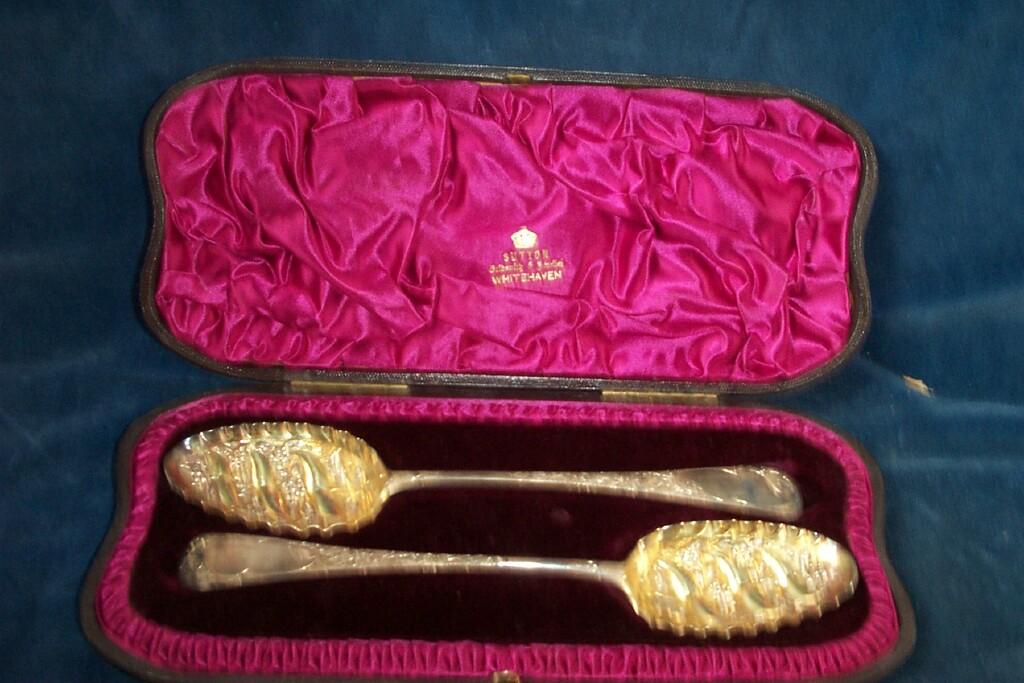 Appraisal: A cased pair of Georgian silver berry spoons with embossed