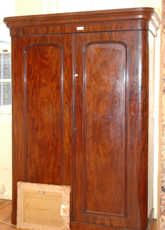 Appraisal: A VICTORIAN FLAME MAHOGANY WARDROBE The rounded rectangular top above