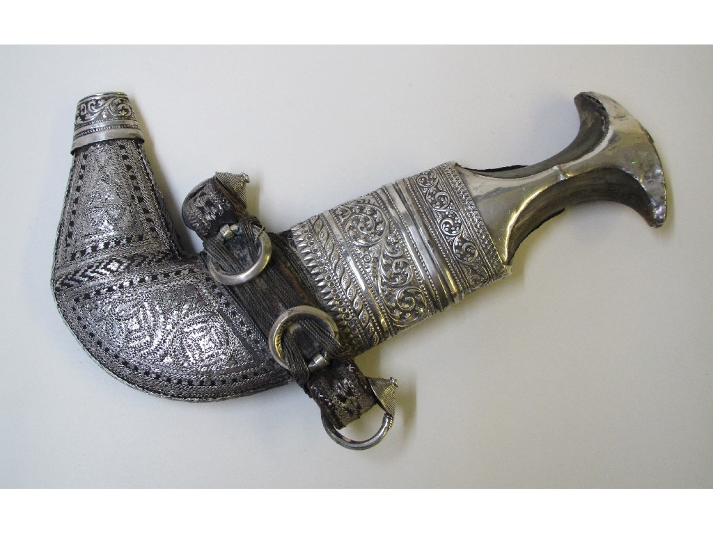 Appraisal: A Persian silver dagger with horn handle and foliate chased