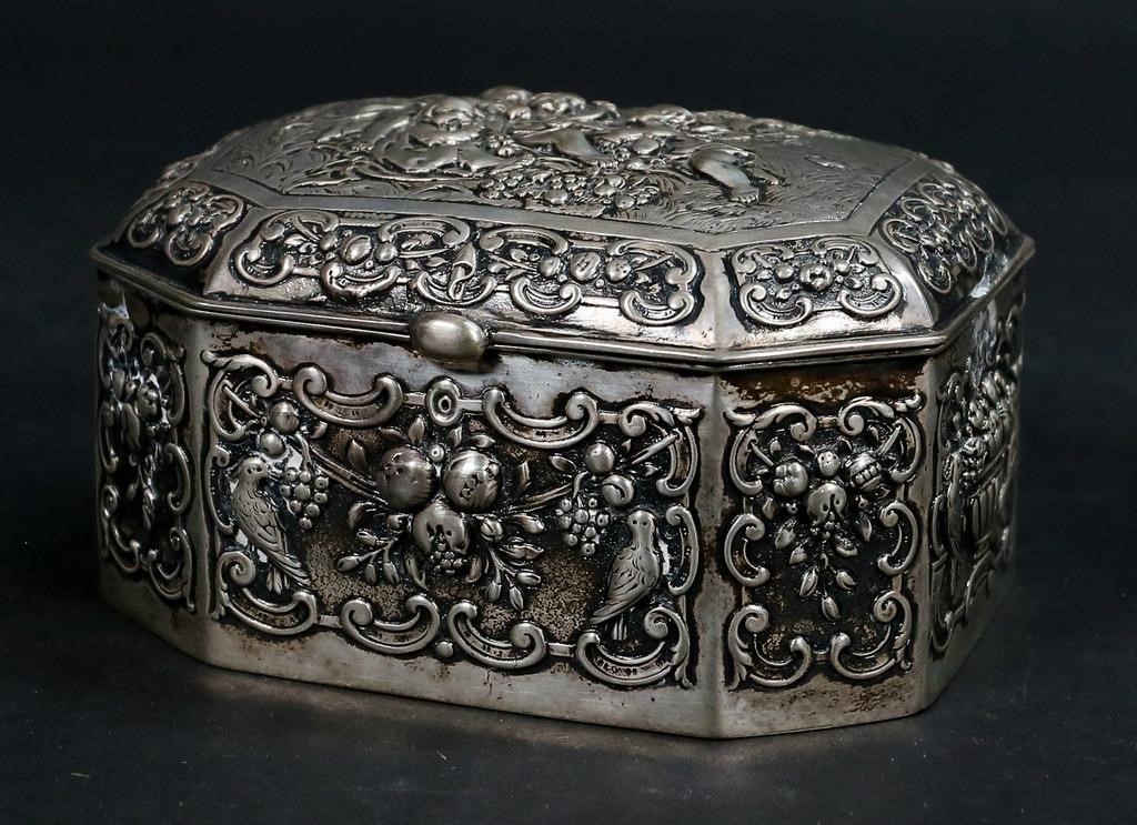 Appraisal: German silver repousse box with putti motif lid German crescent