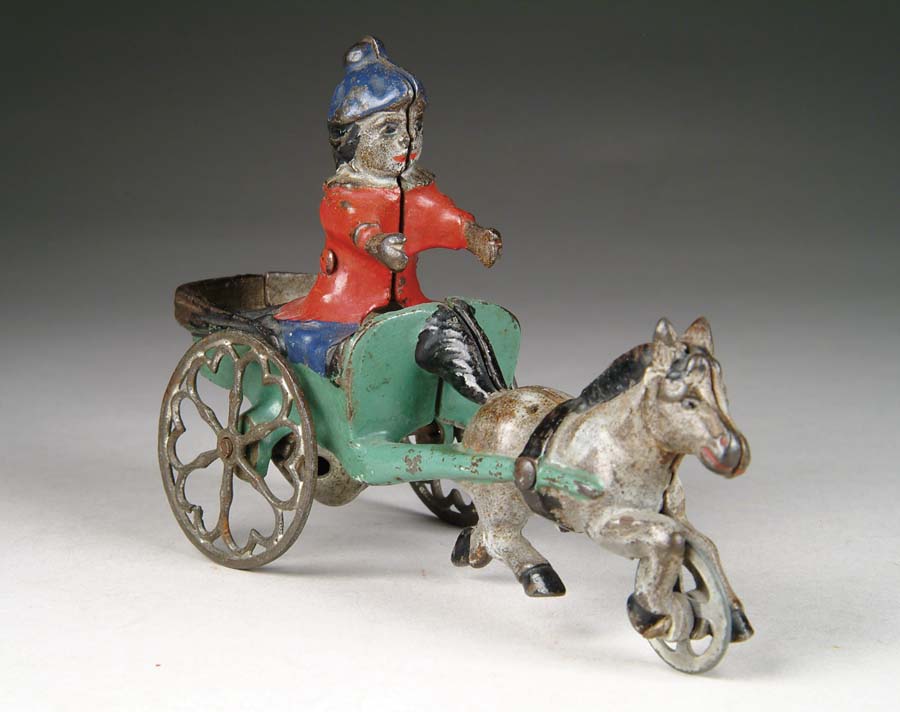 Appraisal: PONY AND CARRIAGE WITH BOY DRIVER BELL TOY Manufactured by