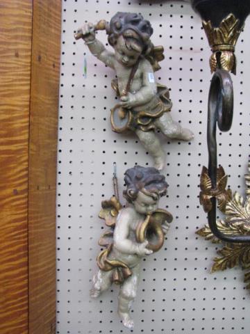 Appraisal: A pair of polychrome angel figures one playing a horn