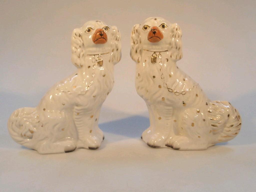 Appraisal: A pair of Victorian Staffordshire comforter dogs in the form