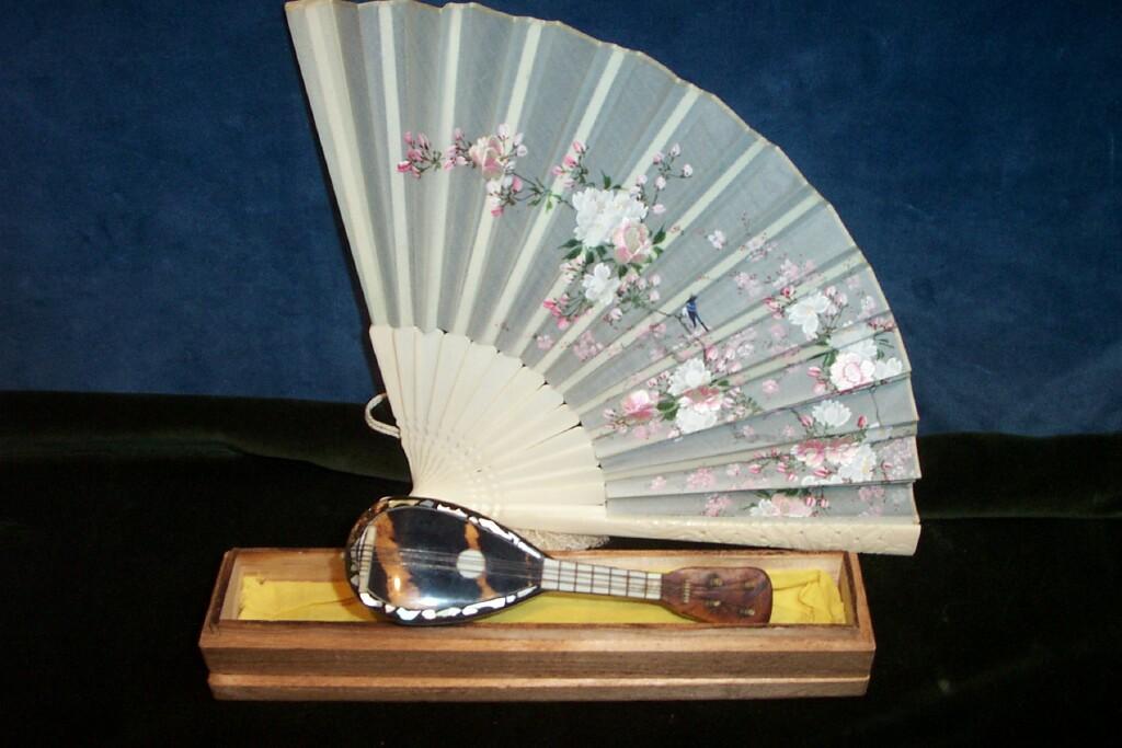 Appraisal: A miniature tortoise shell mandolin and a Japanese ivory fan