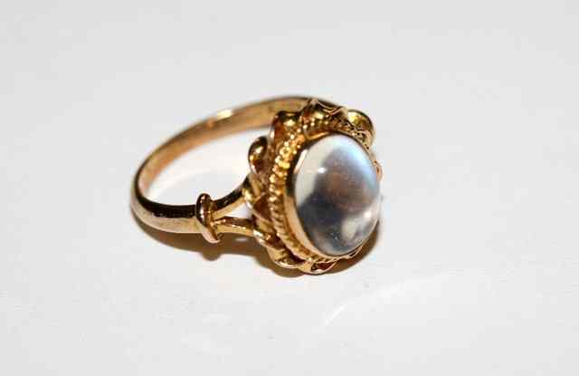 Appraisal: A MOONSTONE DRESS RING with a twisted wire work mount