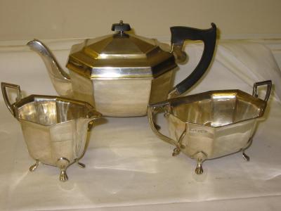 Appraisal: A THREE PIECE TEA SERVICE the teapot of canted oblong