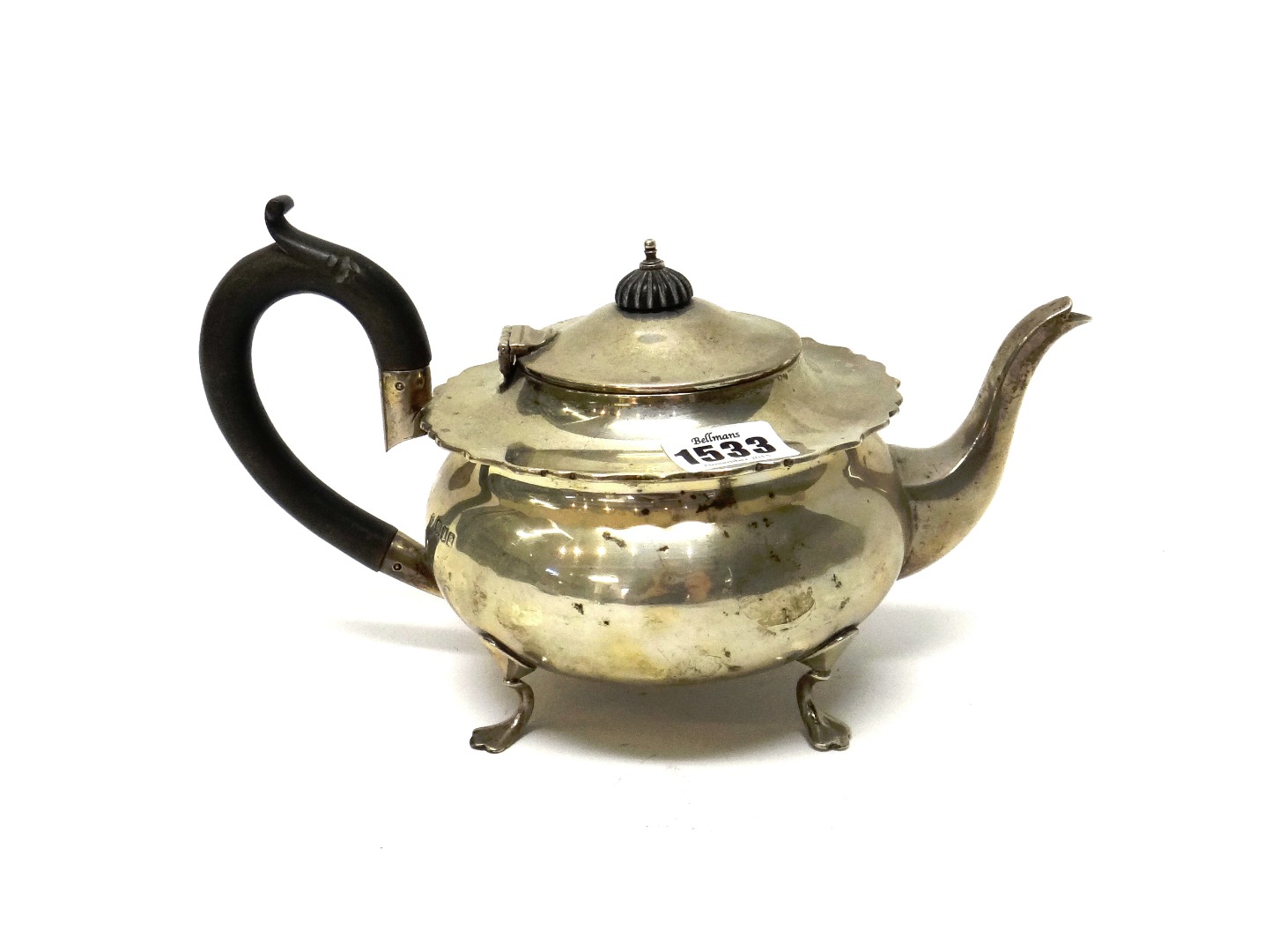 Appraisal: A silver teapot of circular form raised on three feet