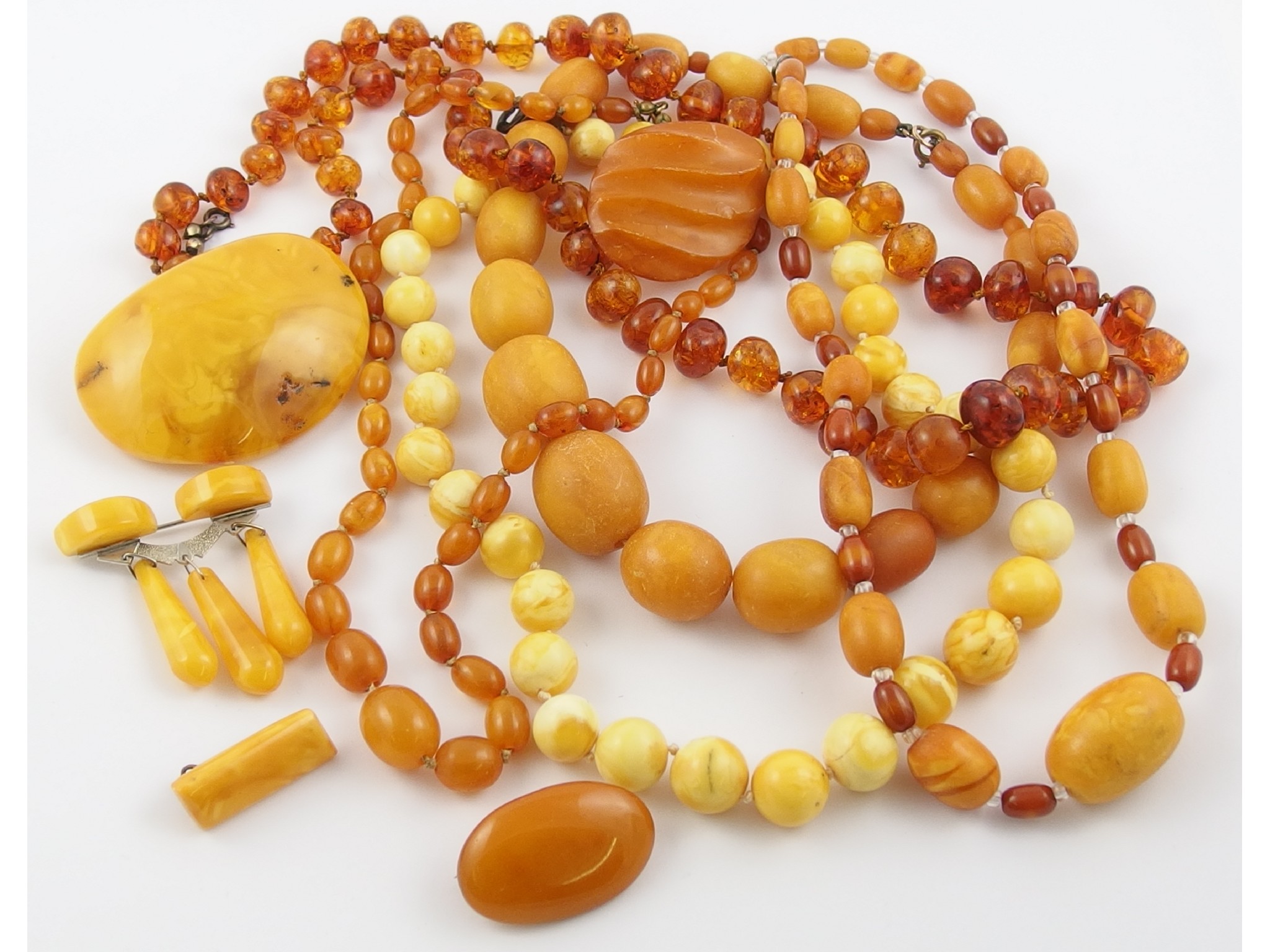 Appraisal: A collection of amber coloured jewelleryto include egg yolk amber