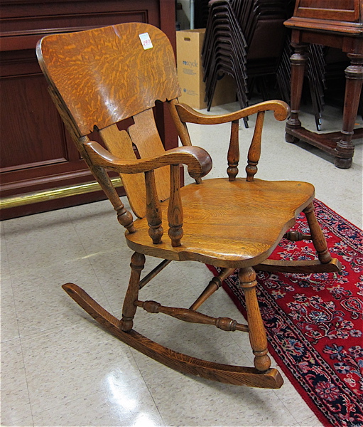 Appraisal: AN OAK ROCKING ARMCHAIR American c