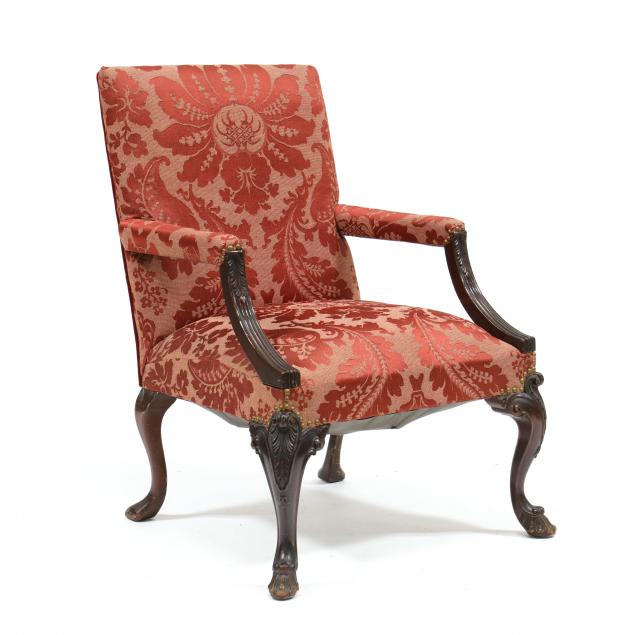 Appraisal: GEORGE II STYLE CARVED MAHOGANY LOLLING CHAIR Early th century