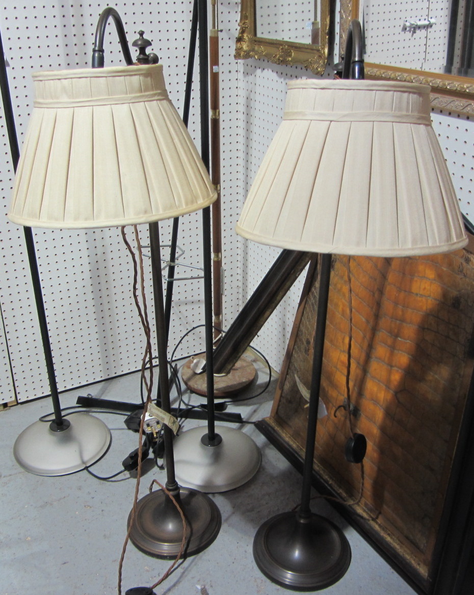 Appraisal: A pair of th century brass adjustable standard lamps