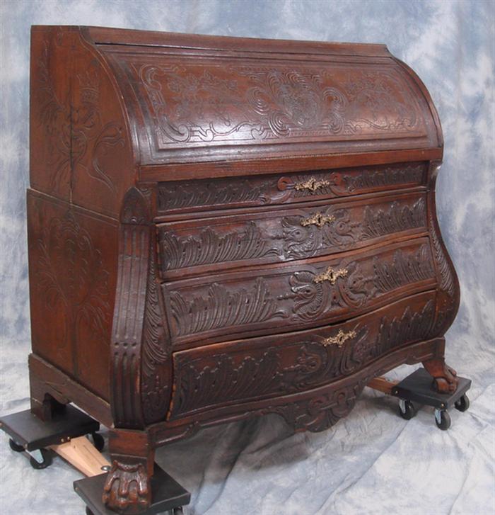 Appraisal: Carved oak Dutch bombe case drawer cylinder roll desk interior