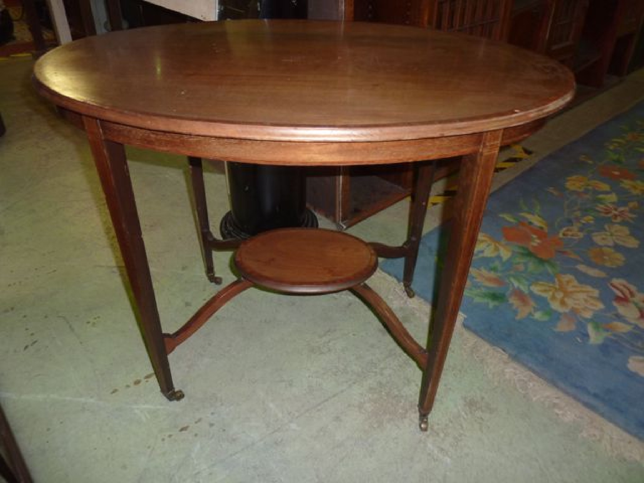 Appraisal: An inlaid Edwardian mahogany occasional table of oval form with