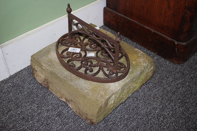 Appraisal: A CAST IRON BOOT SCRAPER of scrolling form and mounted