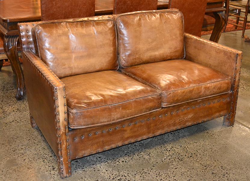 Appraisal: AN ART DECO STYLE STUDDED LEATHER TWO SEAT SOFA cm