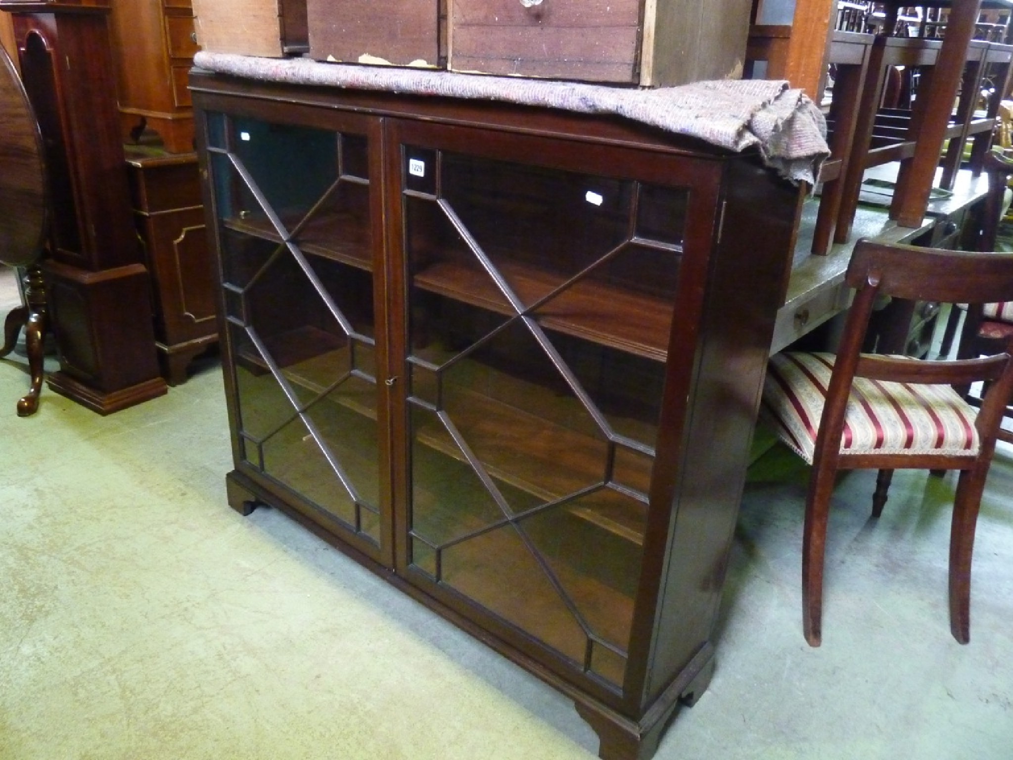 Appraisal: An Edwardian mahogany bookcase side cabinet in the Georgian style