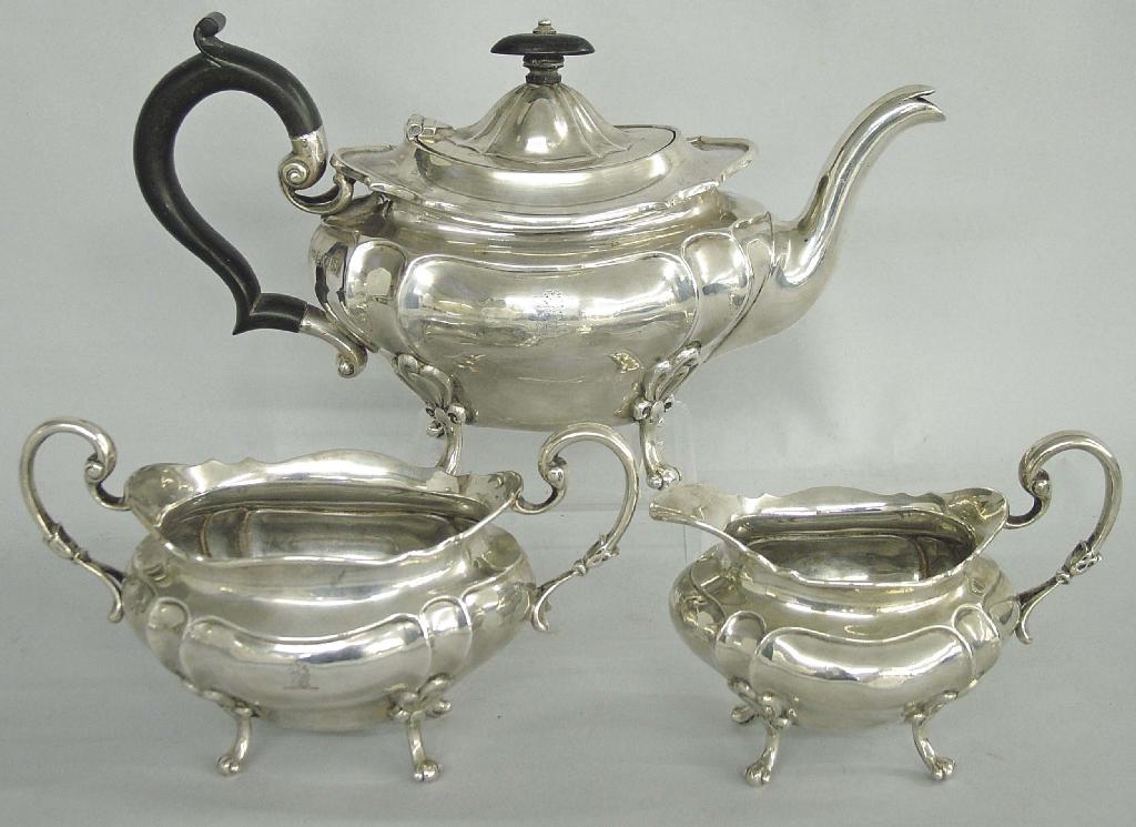 Appraisal: Three piece oval lobed tea set upon four scrolling feet