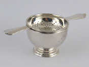 Appraisal: A silver tea strainer and bowl Glasgow Wt gms