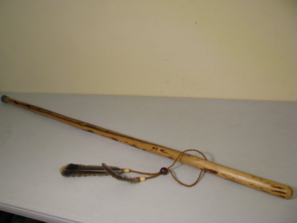 Appraisal: Knotty pine smooth walking stick with feathers and several beads