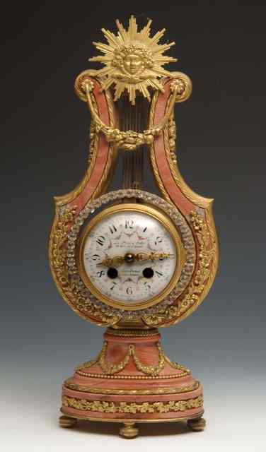 Appraisal: A FRENCH ORMOLU MOUNTED ROSE MARBLE LYRE CLOCK the top