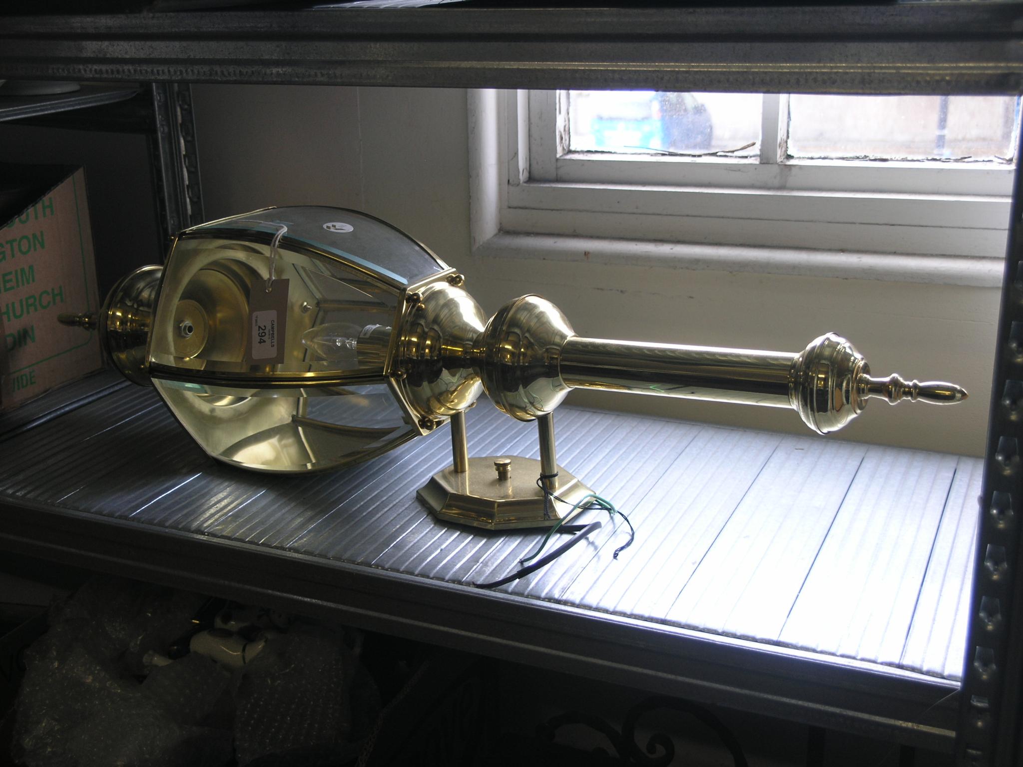 Appraisal: A period-style brass porch lamp with bevelled glass chamber in