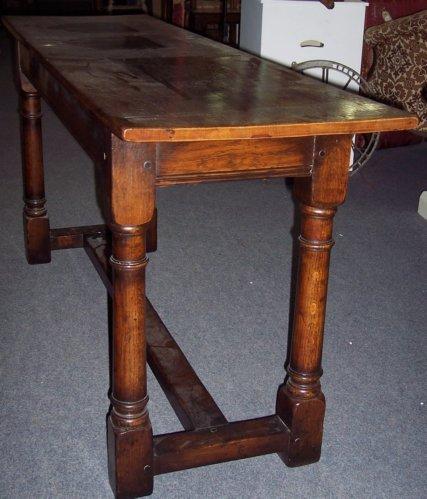 Appraisal: An oak table the rectangular top on gun barrel legs