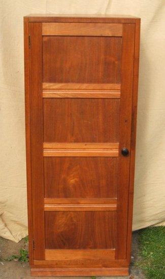 Appraisal: A walnut bookcase by Gordon Russell enclosed by a single